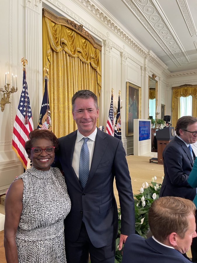 @MignonClyburn and Mike Galvin @GraniteTelecom standing in front of stage at the White House.